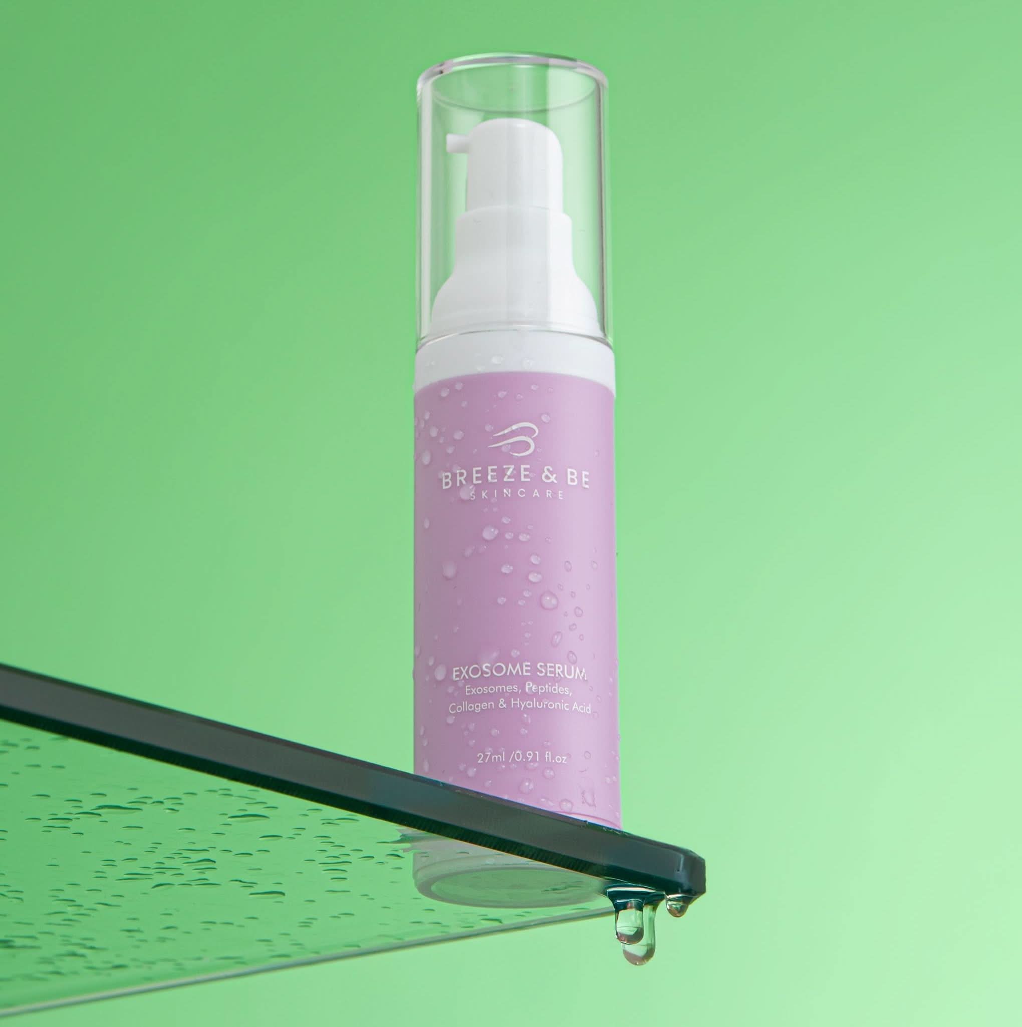 Purple exosome serum bottle with pump on a green background