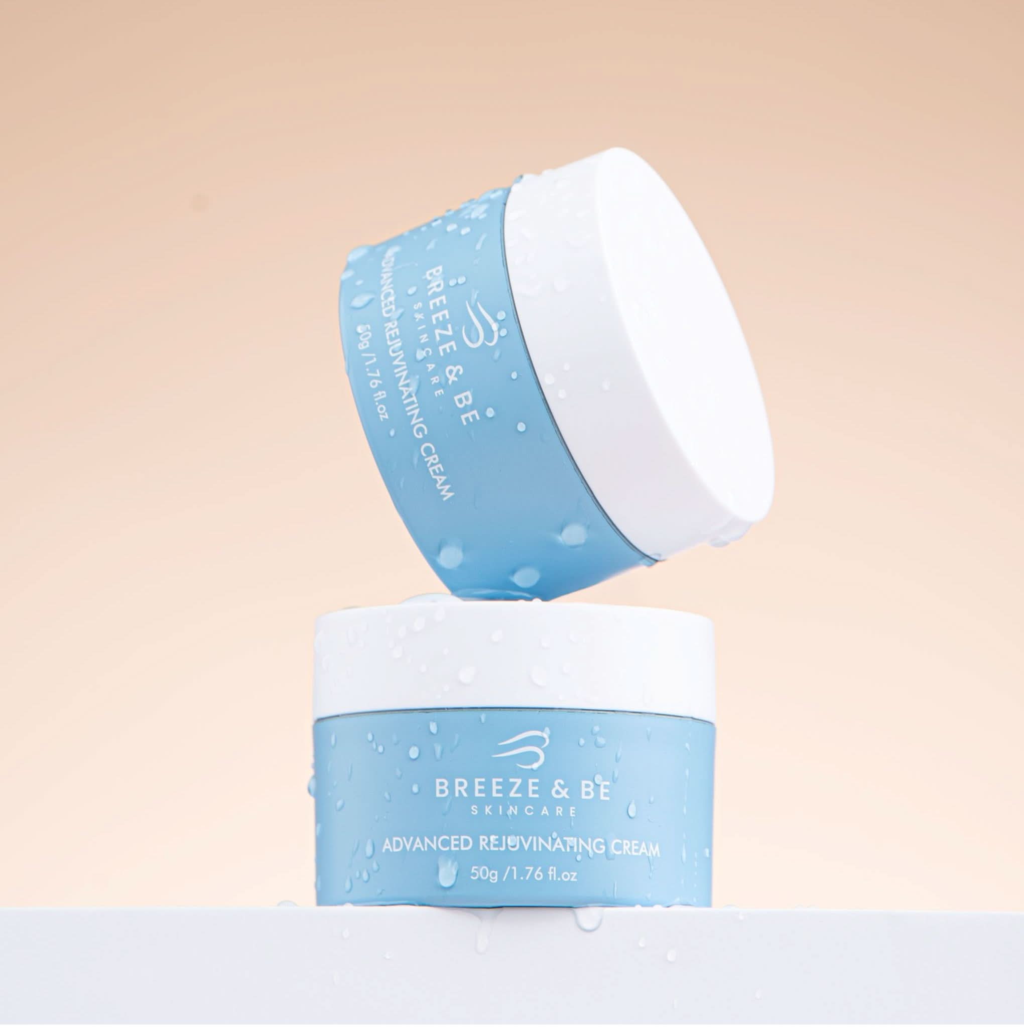 Two containers of Breeze & Be skincare cream on a beige background
