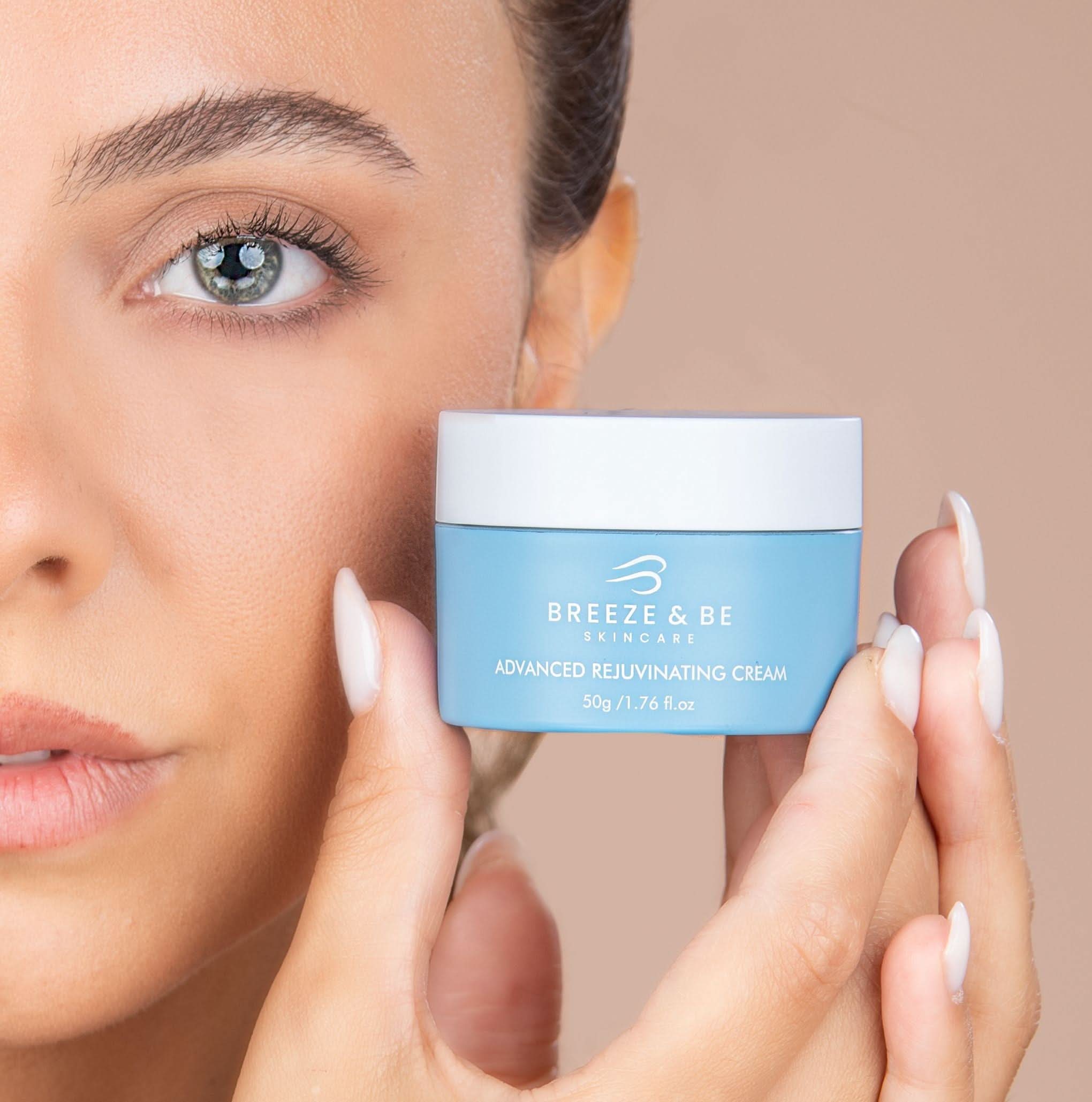 Woman holding a jar of Breeze & Bee skincare cream against a neutral background