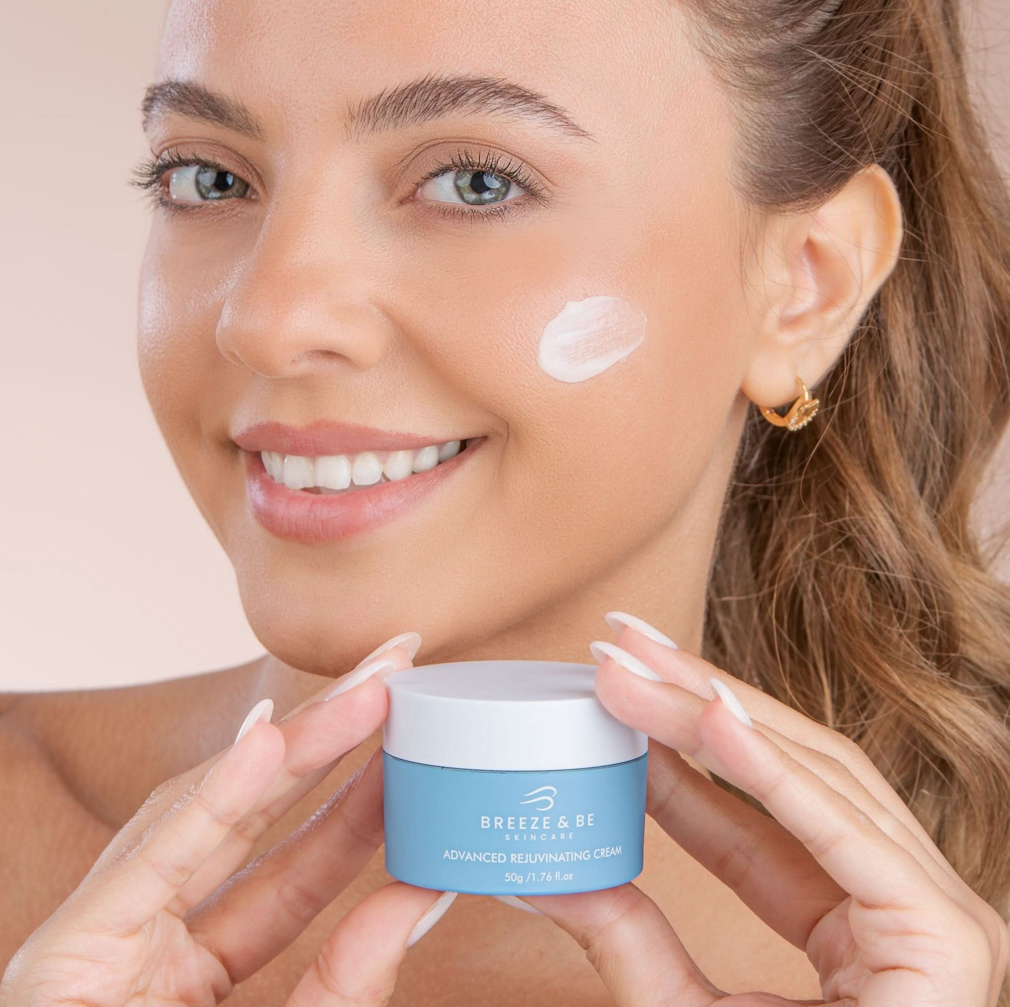 Woman applying cream to her face with a jar of Breeze & Be cream.