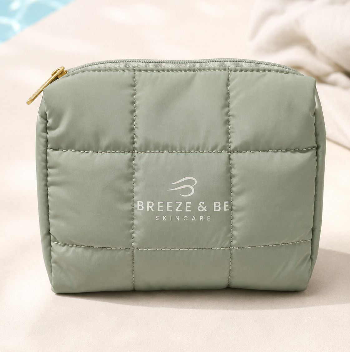 Sage green quilted Breeze &amp; Be skincare pouch with the logo on the front